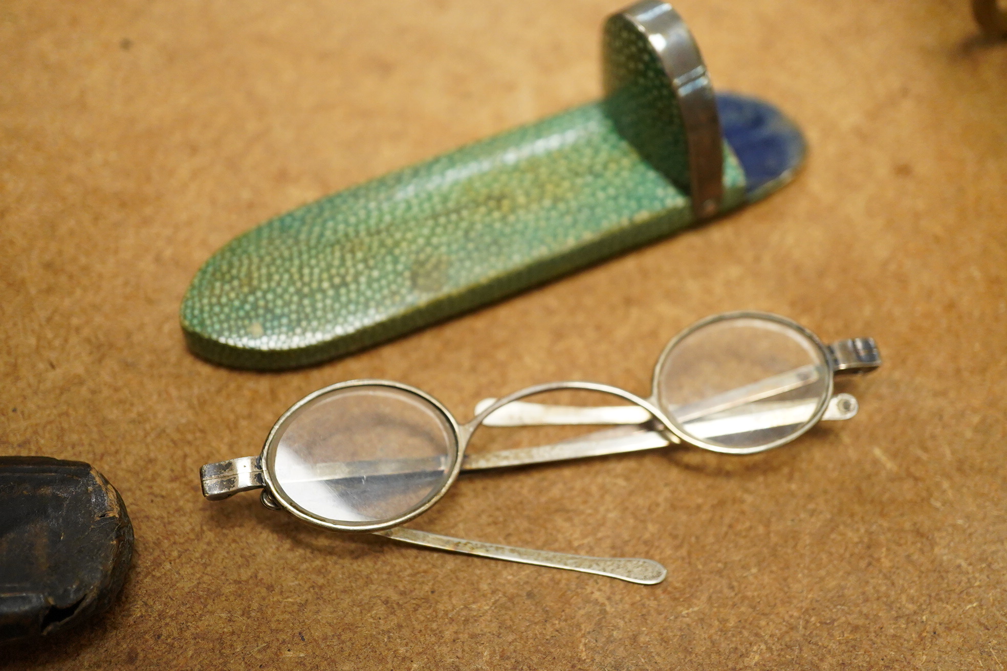 A pair of George III silver framed turn pin spectacles, mm. IH, London 1816, shagreen case, a pair of William IV silver slider spectacles by Thomas Millington, Birmingham, card case (2)